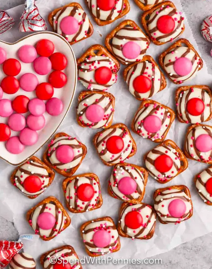 valentines day snacks: square pretzels topped with chocolate and red and pink candies.' title='31 Valentine’s Day Snacks That Make Sweet Lunchbox Treats