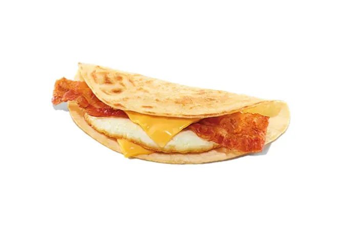 Keto at Dunkin Donuts - One of Dunkin’s Wake Up Wraps with bacon egg and cheese inside of it. It sits in front of a white background.' title='How to Eat Keto at Dunkin’ Donuts: 15 Low-Carb Foods and Drinks We Love