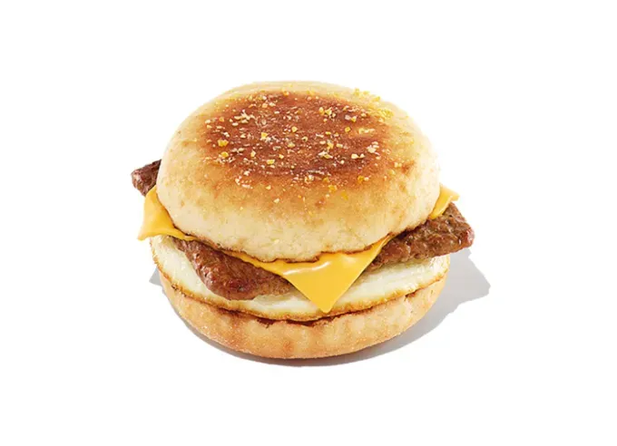 Keto at Dunkin Donuts - An English muffin with turkey sausage egg and cheese on a white background.' title='How to Eat Keto at Dunkin’ Donuts: 15 Low-Carb Foods and Drinks We Love