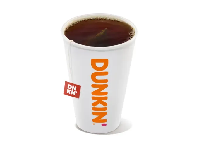 Keto at Dunkin Donuts - A cup of dark hot tea from Dunkin on a white background.' title='How to Eat Keto at Dunkin’ Donuts: 15 Low-Carb Foods and Drinks We Love