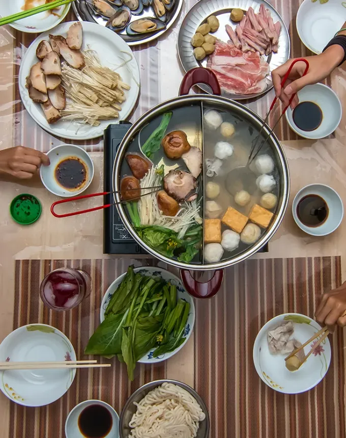 traditional chinese foods: aerial view of communal hot pot' title='20 Traditional Chinese Food Dishes You Need to Try According to a Chinese-Malaysian Chef