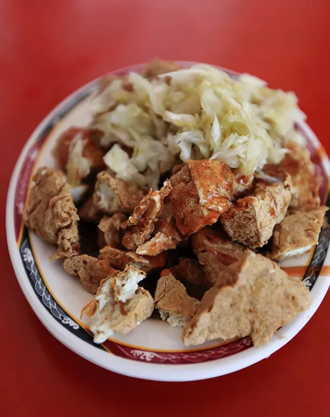 traditional chinese foods: stinky tofu on a plate' title='20 Traditional Chinese Food Dishes You Need to Try According to a Chinese-Malaysian Chef