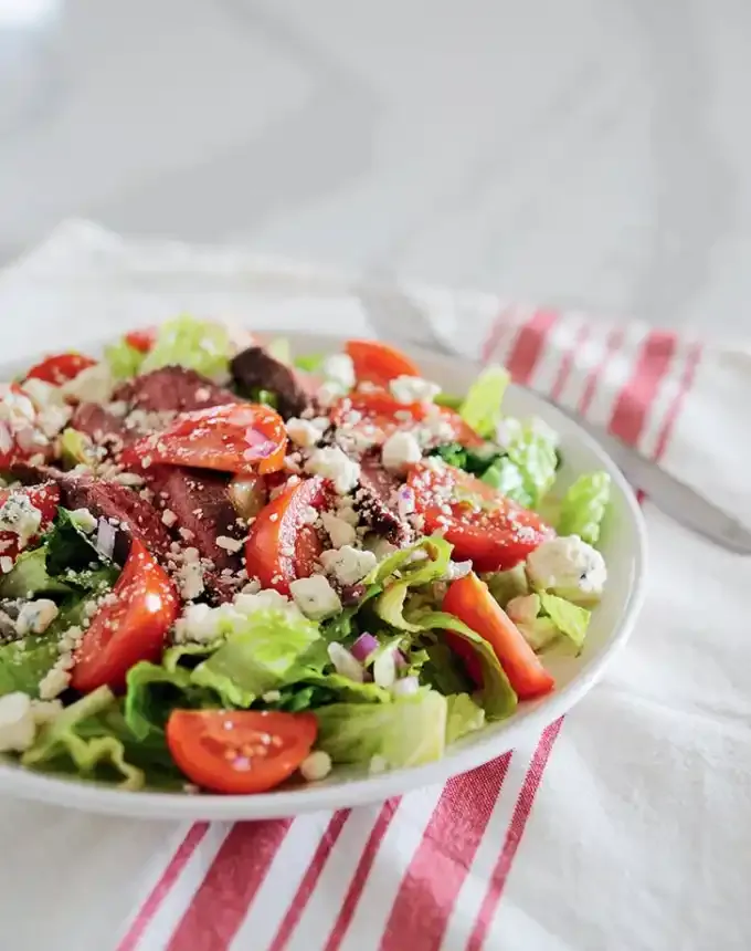 easy lunch ideas: plate of steak blue cheese salad on a pink and white linen' title='82 Easy Lunch Ideas That Are Fast Low-Fuss and Foolproof