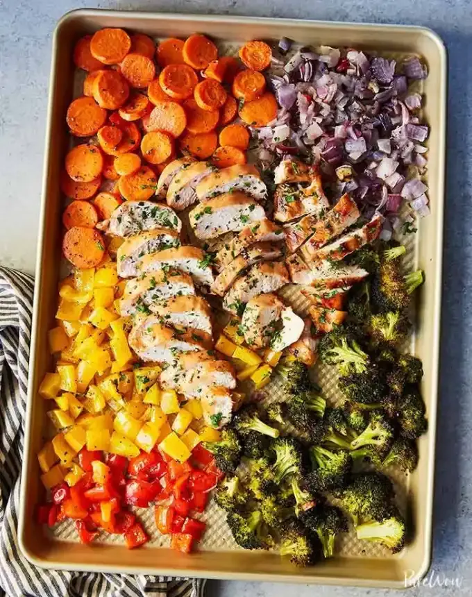 easy lunch ideas: sheet pan of assorted chopped vegetables and cut chicken breast' title='82 Easy Lunch Ideas That Are Fast Low-Fuss and Foolproof