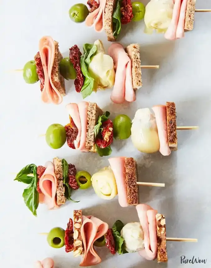 easy lunch ideas: lunch kebabs on a marble counter with mortadella artichoke and sun-dried tomatoes' title='82 Easy Lunch Ideas That Are Fast Low-Fuss and Foolproof