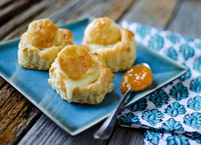 brie recipes: brie apricot puffs on a plate' title='The 43 Most Delicious Brie Recipes That Put the Cheese Front and Center