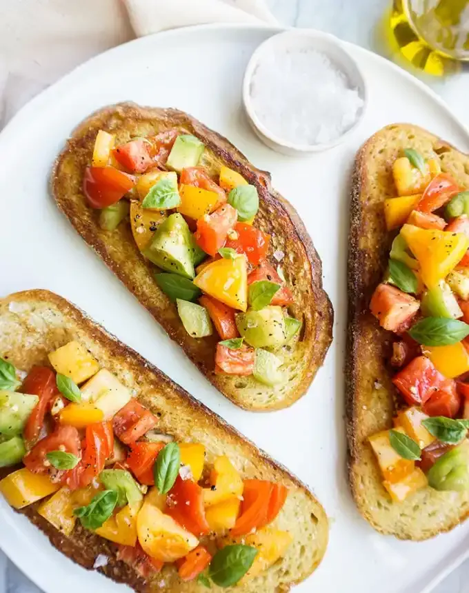 fancy appetizers: heirloom tomato bruschetta' title='40 Fancy Appetizers That Are Secretly Really Easy to Make