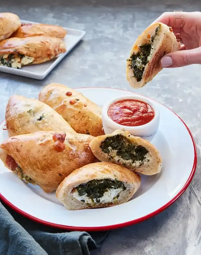 fancy appetizers: mini spinach ricotta calzones' title='40 Fancy Appetizers That Are Secretly Really Easy to Make