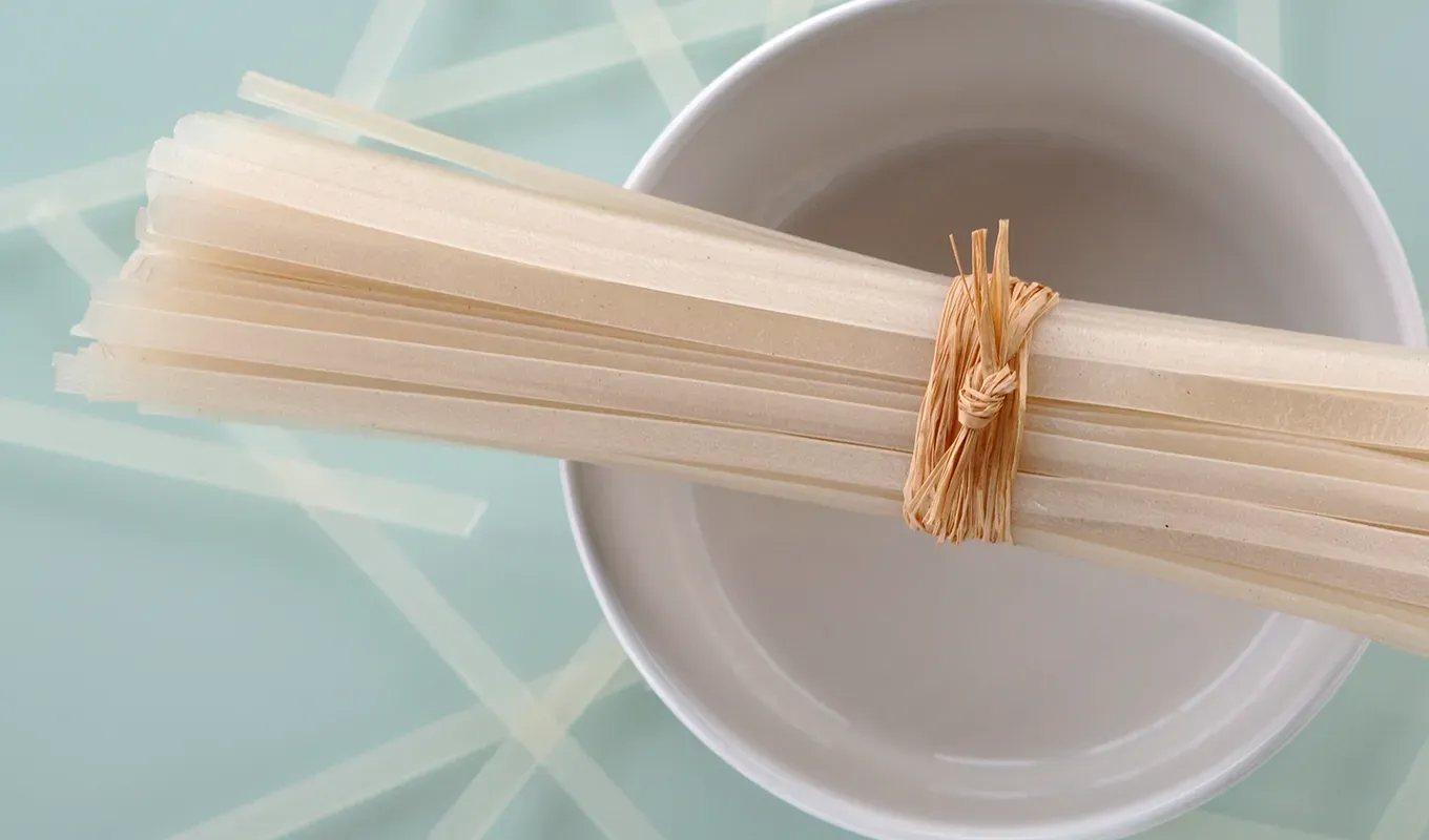 are rice noodles healthy: a bowl of dried rice noodles' fetchpriority='auto' title='Yeah They’re Gluten-Free But Are Rice Noodles Healthy?