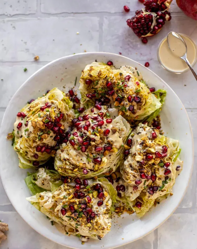 what to serve with lamb: broiled wedge salad with pomegranates and pistachios' title='The 46 Best Side Dishes for Lamb to Serve at Dinner Parties Barbecues and Beyond