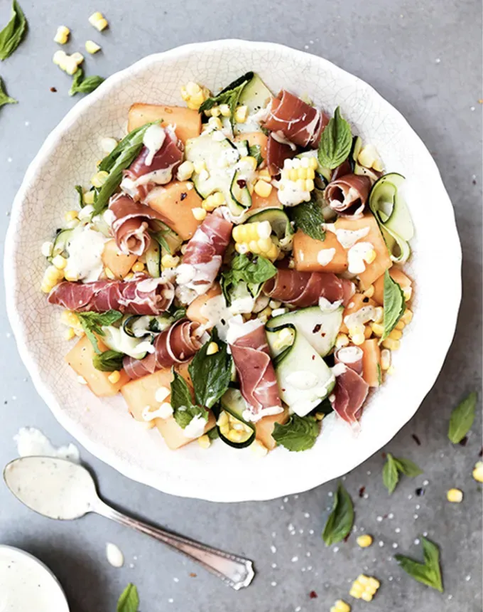 what to serve with lamb: corn zucchini cantaloupe and prosciutto salad' title='The 46 Best Side Dishes for Lamb to Serve at Dinner Parties Barbecues and Beyond