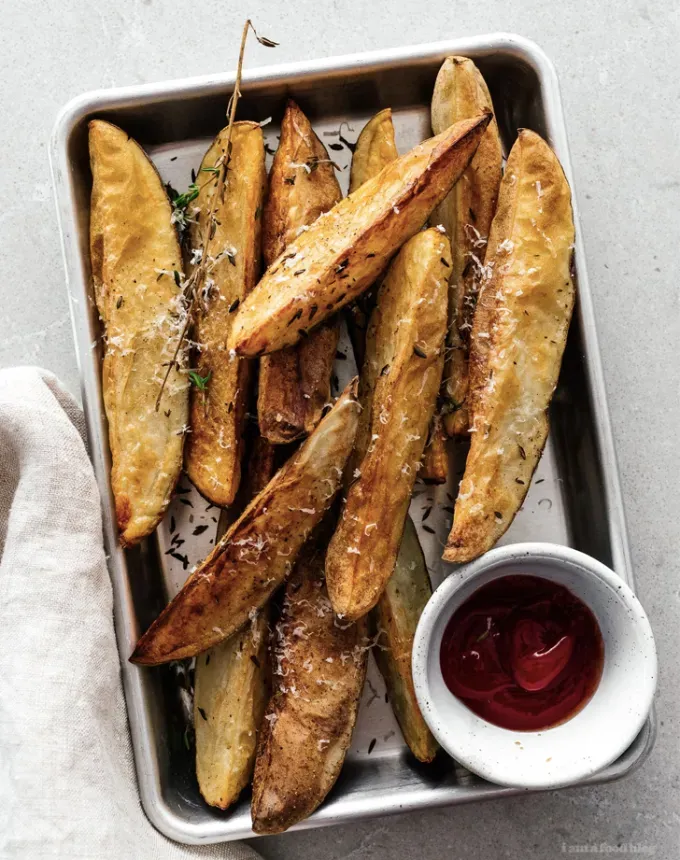 what to serve with lamb: parmesan and thyme roasted potato wedges' title='The 46 Best Side Dishes for Lamb to Serve at Dinner Parties Barbecues and Beyond