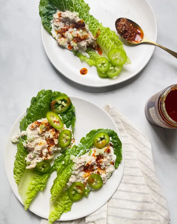 easy dinner recipes: two plates of tuna-filled lettuce cups topped with chile crisp' title='65 Easy Dinner Recipes for Beginners (That Even the Most Culinarily Challenged Can Manage)