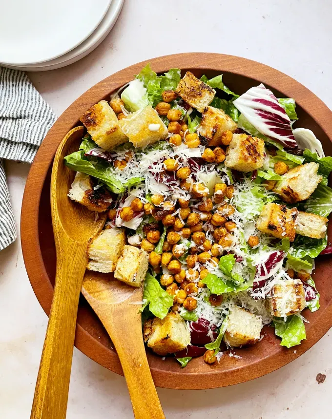 easy dinner recipes: large serving bowl of chickpea caesar salad on a table' title='65 Easy Dinner Recipes for Beginners (That Even the Most Culinarily Challenged Can Manage)