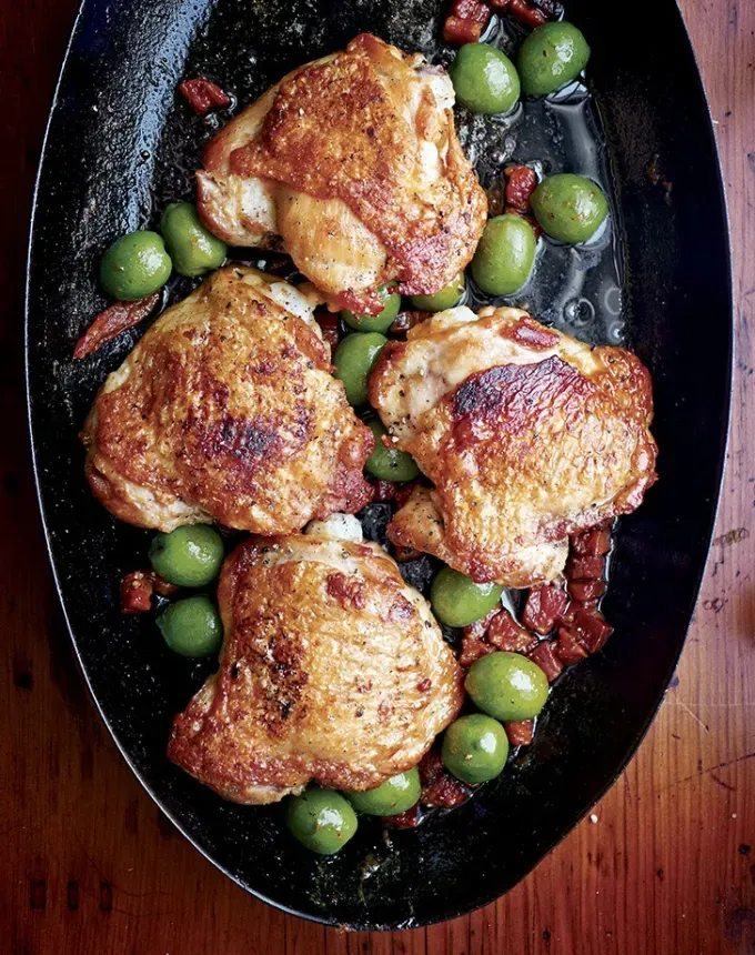 chicken holiday recipes: chicken thighs with pancetta and green olives' title='50 Easy Christmas Chicken Recipes That Are Perfect for the Holidays