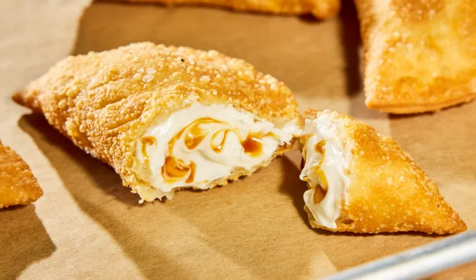 salted caramel and toffee empanada' fetchpriority='auto' title='Taco Bell Is Launching 30 New Menu Items. Here’s What’s Worth Ordering