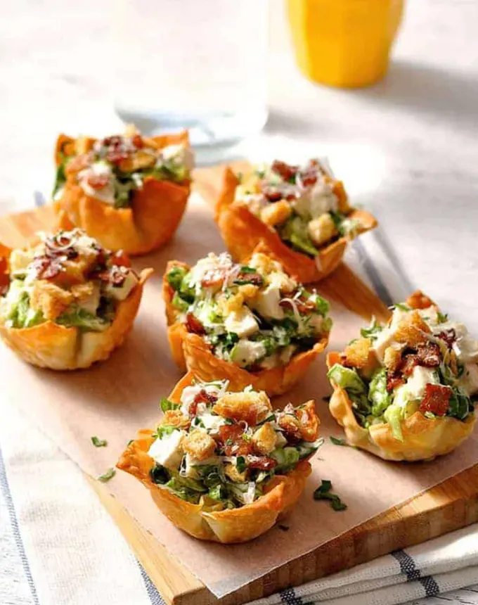 christmas snacks: Caesar Salad Wonton Cups' title='65 Christmas Snacks Even the Busiest Hosts Can Pull Off
