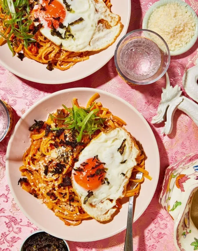 easy asian noodle recipes: cheesy kimchi linguine with gochujang butter topped with fried eggs' title='26 Easy Asian Noodle Recipes You’ll Want to Add to Your Weekly Rotation