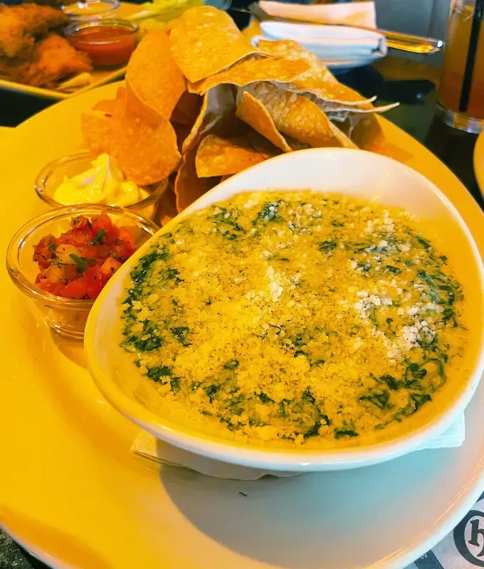 cheesecake factory happy hour appetizers spinach dip 2' title='I Tasted Every Appetizer on Cheesecake Factory’s Happy Hour Menu—Here’s How They Rank