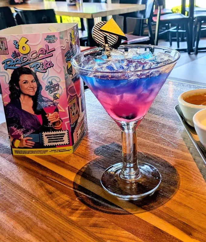 chili’s radical ’rita margarita of the month: chili’s radical ’rita margarita on a table' title='Chili’s Margarita of the Month Is Totally ’90s *and* Delicious—Here’s an Editor’s Review