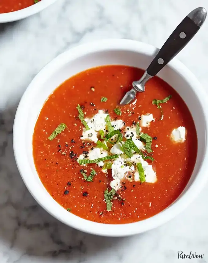 best big-batch recipes: bowl of roasted tomato soup finished with herbs and goat cheese' title='76 Big-Batch Dishes & Recipes to Feed a Crowd