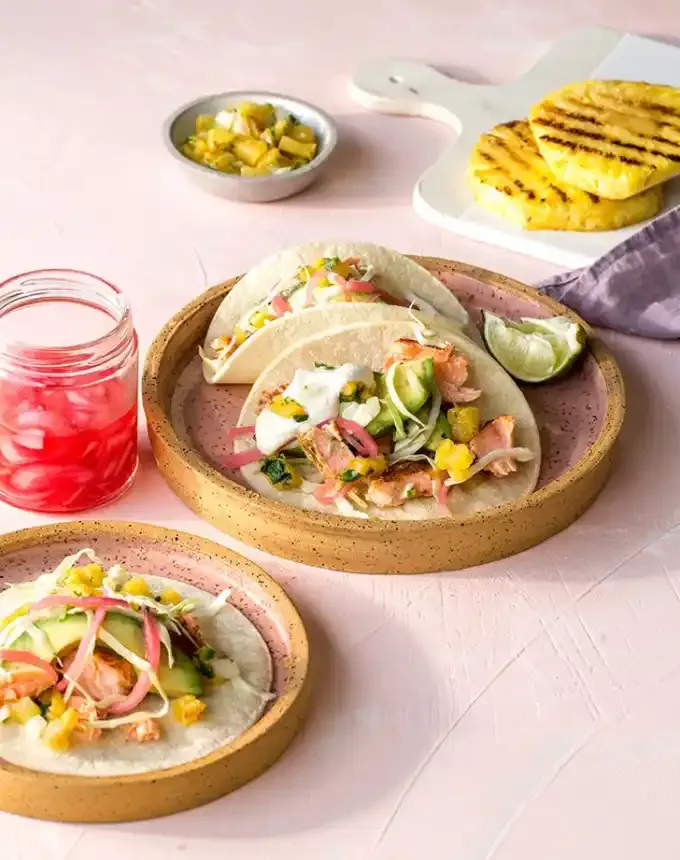 best big-batch recipes: roasted salmon tacos with pickled onions and pineapple salsa on plates' title='76 Big-Batch Dishes & Recipes to Feed a Crowd