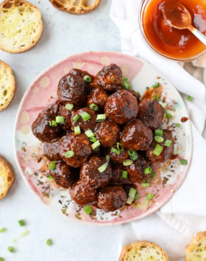 best big-batch recipes: stack of slow cooker chipotle bbq meatballs with garlic toast on a plate' title='76 Big-Batch Dishes & Recipes to Feed a Crowd