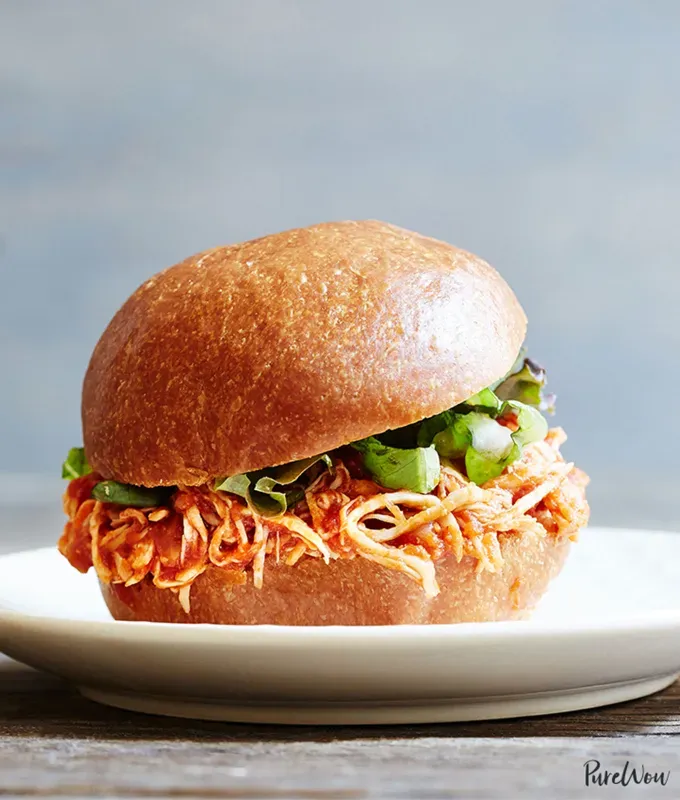 best big-batch recipes: close-up of slow cooker pulled chicken sandwich on a plate' title='76 Big-Batch Dishes & Recipes to Feed a Crowd