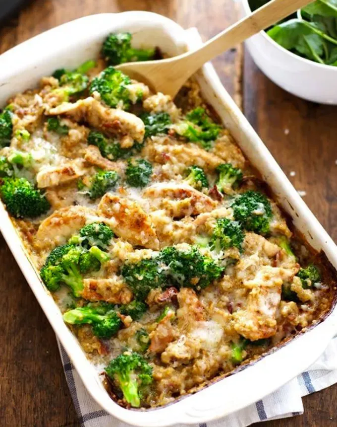 best big-batch recipes: chicken quinoa broccoli casserole in a baking dish with a serving spoon' title='76 Big-Batch Dishes & Recipes to Feed a Crowd