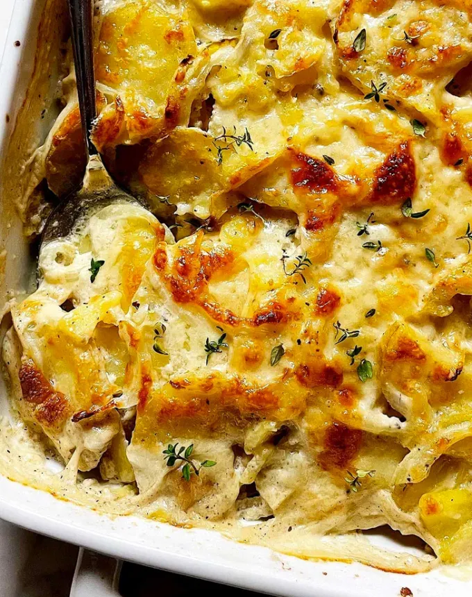 best big-batch recipes: close-up of potatoes au gratin in a baking dish' title='76 Big-Batch Dishes & Recipes to Feed a Crowd