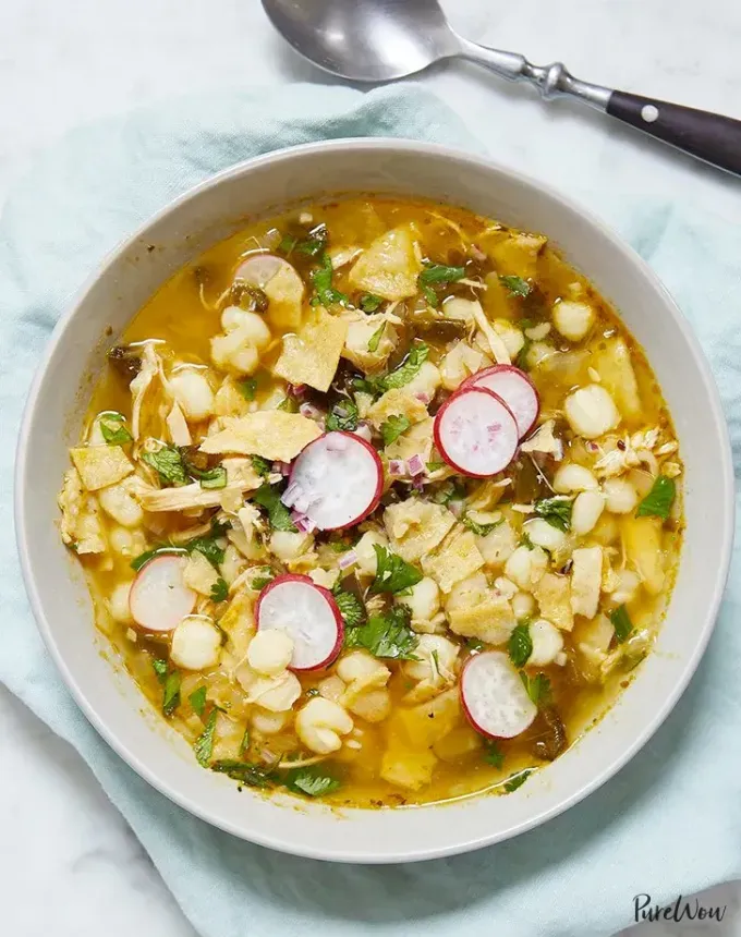 october dinners: bowl of mexican posole topped with cilantro and sliced radishes' title='31 October Dinner Ideas That Are Just Right for Sweater Weather