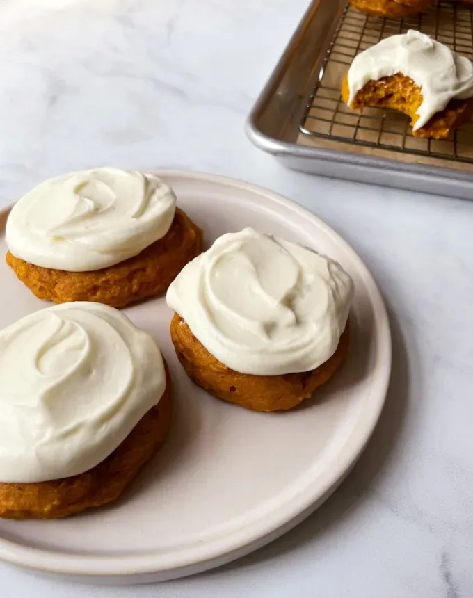 mini thanksgiving dessert recipes: pumpkin cookies with cream cheese frosting' title='54 Mini Thanksgiving Desserts That Are (Almost) Too Cute to Eat