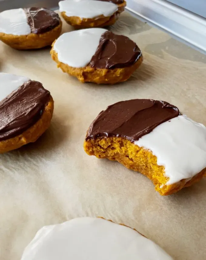 mini thanksgiving dessert recipes: pumpkin black and white cookies' title='54 Mini Thanksgiving Desserts That Are (Almost) Too Cute to Eat