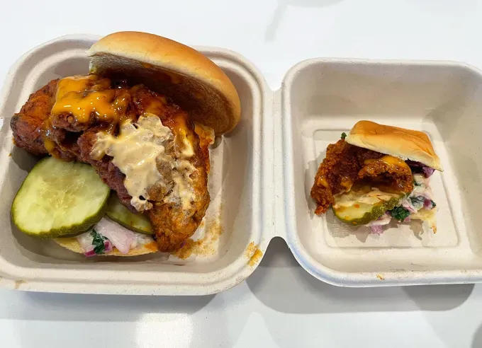 dave’s hot chicken mini sliders review: dave’s hot chicken mini slider next to a regular sized slider' title='Dave’s Hot Chicken Just Launched a *Micro* Version of Its Cult-Favorite Chicken Sliders—Here’s My Review