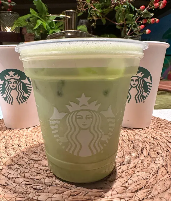 An image of the new and improved iced matcha latte in a classic transparent Starbucks cup' fetchpriority='auto' title='ATTN: Starbucks Finally Has Cortado! Here’s My Honest Review of the New Winter Menu