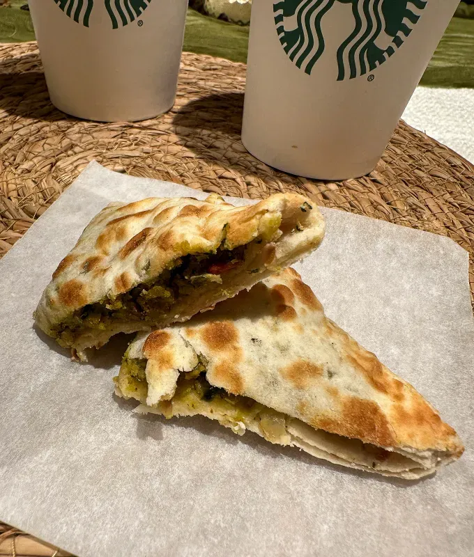 An image of the spicy falafel pocket cut into two triangles stacked on top of each other' fetchpriority='auto' title='ATTN: Starbucks Finally Has Cortado! Here’s My Honest Review of the New Winter Menu