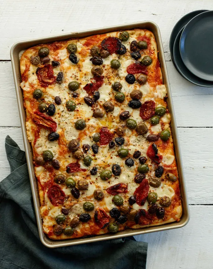 fall vegetarian recipes: baking sheet pizza with olives' title='30 Fall Vegetarian Recipes That Are Cozy Hearty and Packed with Seasonal Produce