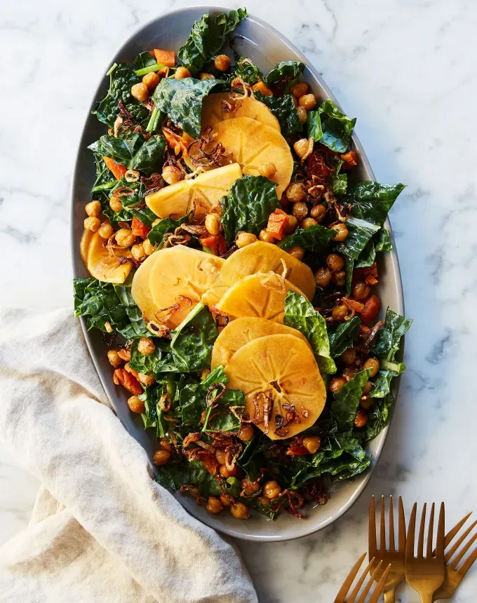 fall vegetarian recipes: kale salad with persimmons' title='30 Fall Vegetarian Recipes That Are Cozy Hearty and Packed with Seasonal Produce