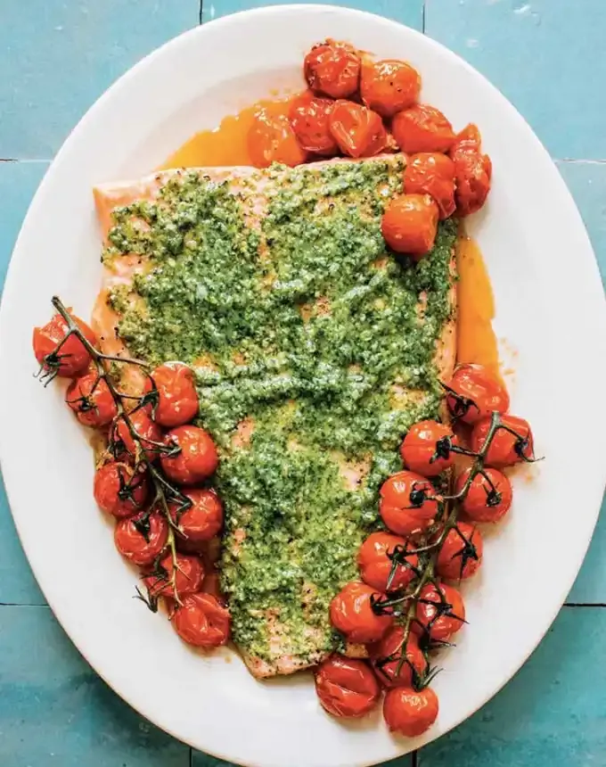 clean eating dinner recipes: salmon with pesto and blistered tomatoes' title='65 Clean-Eating Dinner Recipes for the New Year and Beyond