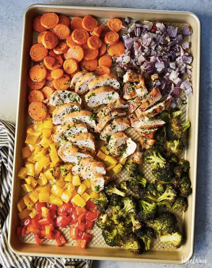 clean eating dinner recipes: sheet pan chicken and rainbow veggies' title='65 Clean-Eating Dinner Recipes for the New Year and Beyond