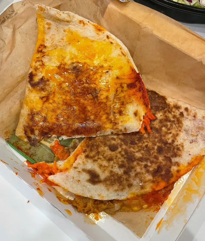 new taco bell menu items review: caliente cantina chicken quesadilla' title='A Food Editor’s Ranking (and Photos) of Taco Bell’s 10 Newest Menu Items Including Toasted Cheddar Street Chalupas