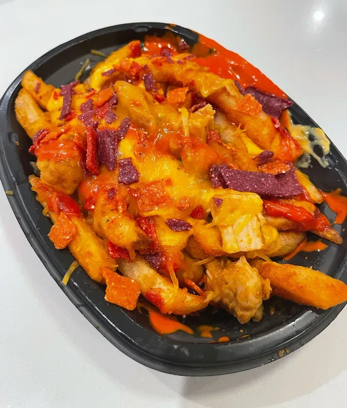 new taco bell menu items review: caliente cantina chicken nacho fries' title='A Food Editor’s Ranking (and Photos) of Taco Bell’s 10 Newest Menu Items Including Toasted Cheddar Street Chalupas