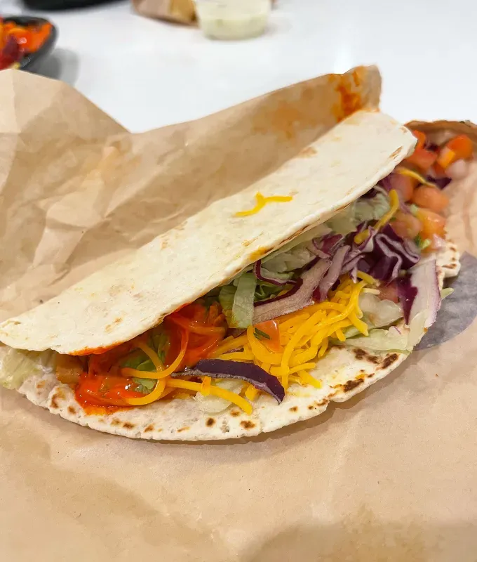 new taco bell menu items review: caliente cantina chicken soft taco' title='A Food Editor’s Ranking (and Photos) of Taco Bell’s 10 Newest Menu Items Including Toasted Cheddar Street Chalupas