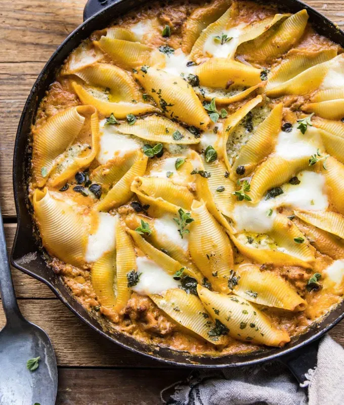fall pasta recipes: spicy pumpkin and pesto cheese shells' title='25 Fall Pasta Recipes to Serve This Season That Taste Like Pure Comfort Food