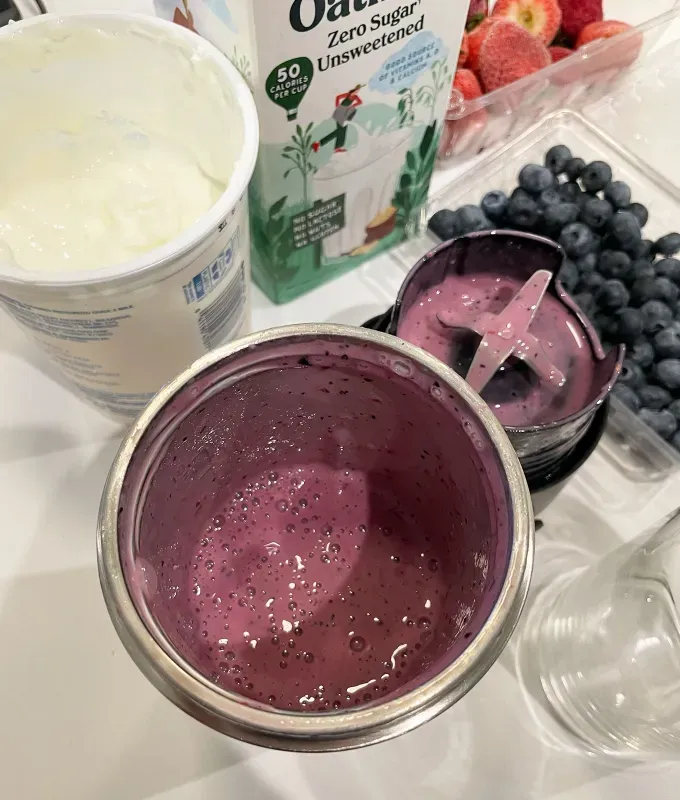 nutribullet flip blender review: nutribullet flip blender with smoothie next to fruit yogurt and oat milk' title='A Food Editor’s Honest Review of the Nutribullet Flip a New Portable Blender