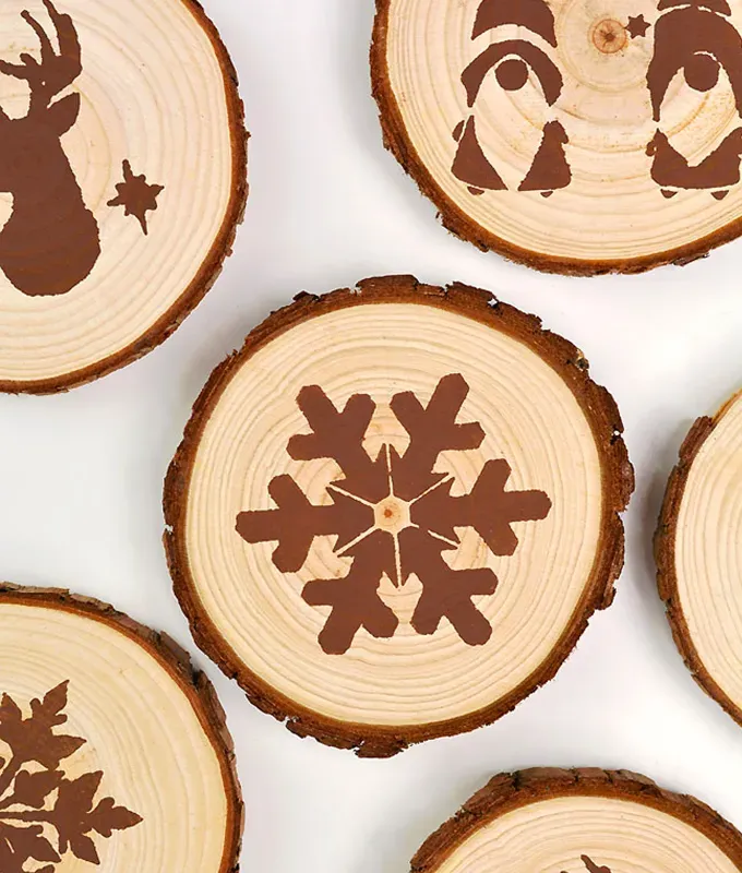 Adult Crafts: DIY Wood Coasters spread out with different designs on them' title='58 Crafts for Adults That Won’t End Up in the Trash in Two Months