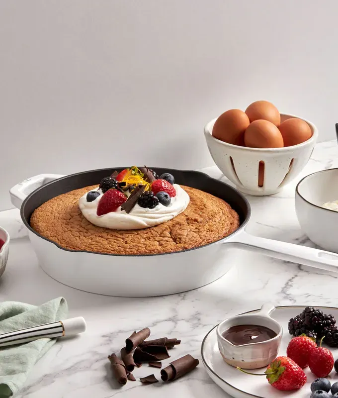 brands like le creuset: milo by kana skillet with a cake baked in it' title='10 Brands Like Le Creuset (Because You Love a Pretty Dutch Oven but Aren’t Made of Money)