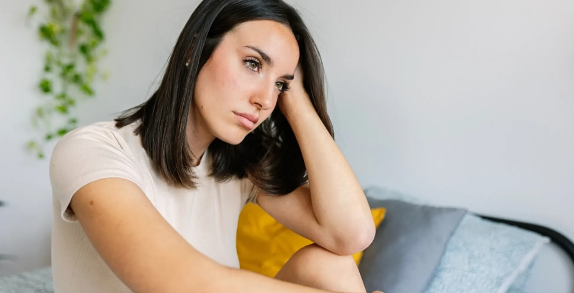 depressed woman sitting on couch' title='signs your body is rejecting your partner according to psychology constant feeling of doom' typeof='foaf:Image' decoding='async