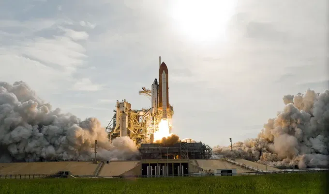 Fall Getaways in Florida - A photo of a large rocket ship taking off at the Kennedy Space Center. There are tons of big gray clouds billowing up from underneath the rocket ship.' title='The 12 Best Fall Getaways in Florida (Because There’s Way More to See Than Just Beaches)