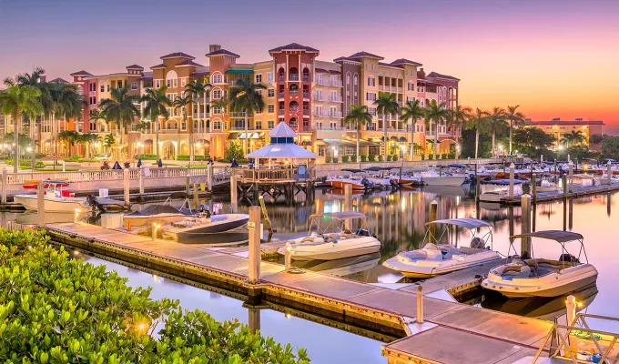Most Beautiful Places in Florida: Naples Florida USA town skyline on the water at dawn.' title='The 14 Most Beautiful Places in Florida